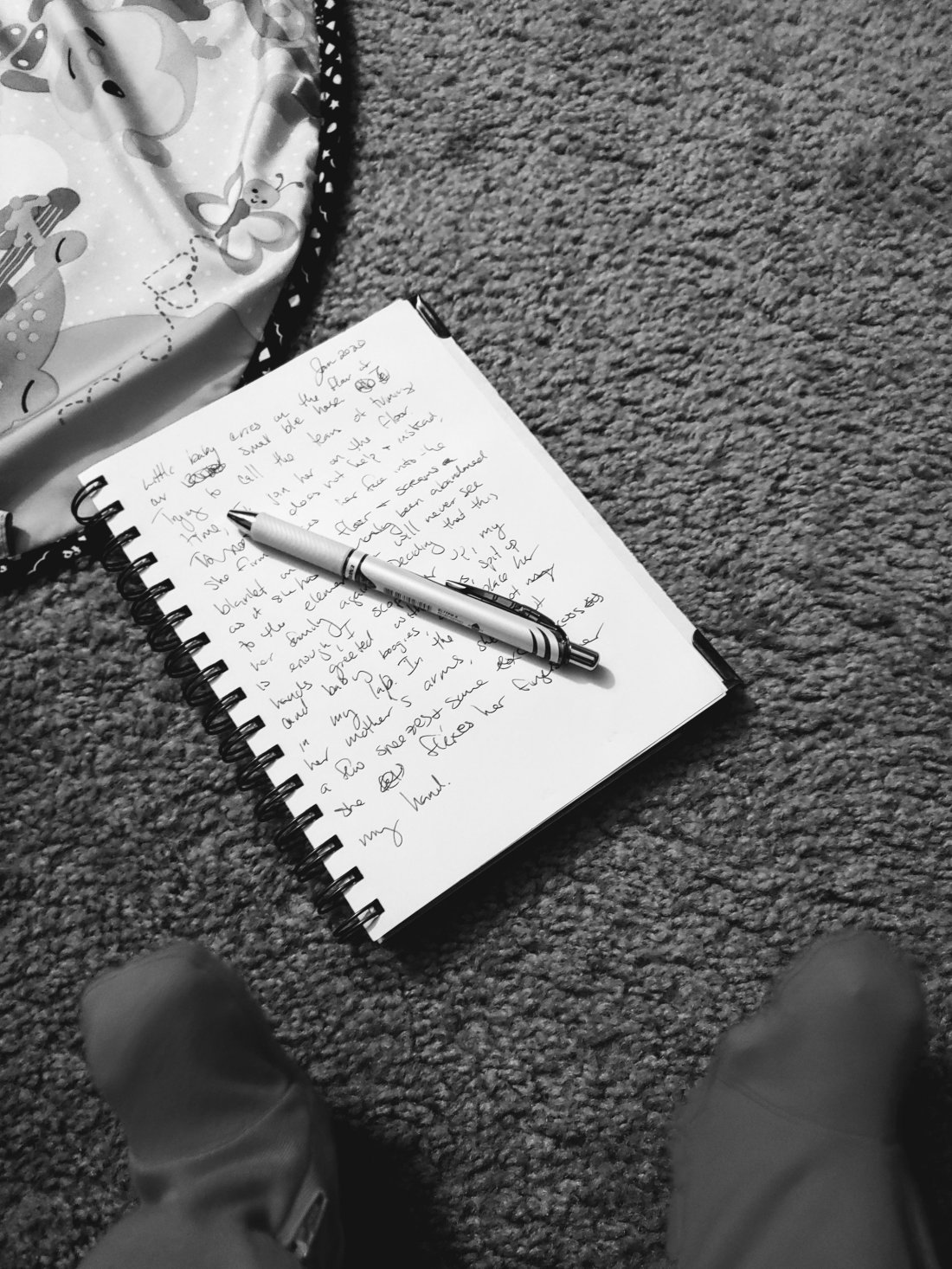 Notebook, pen and baby feet